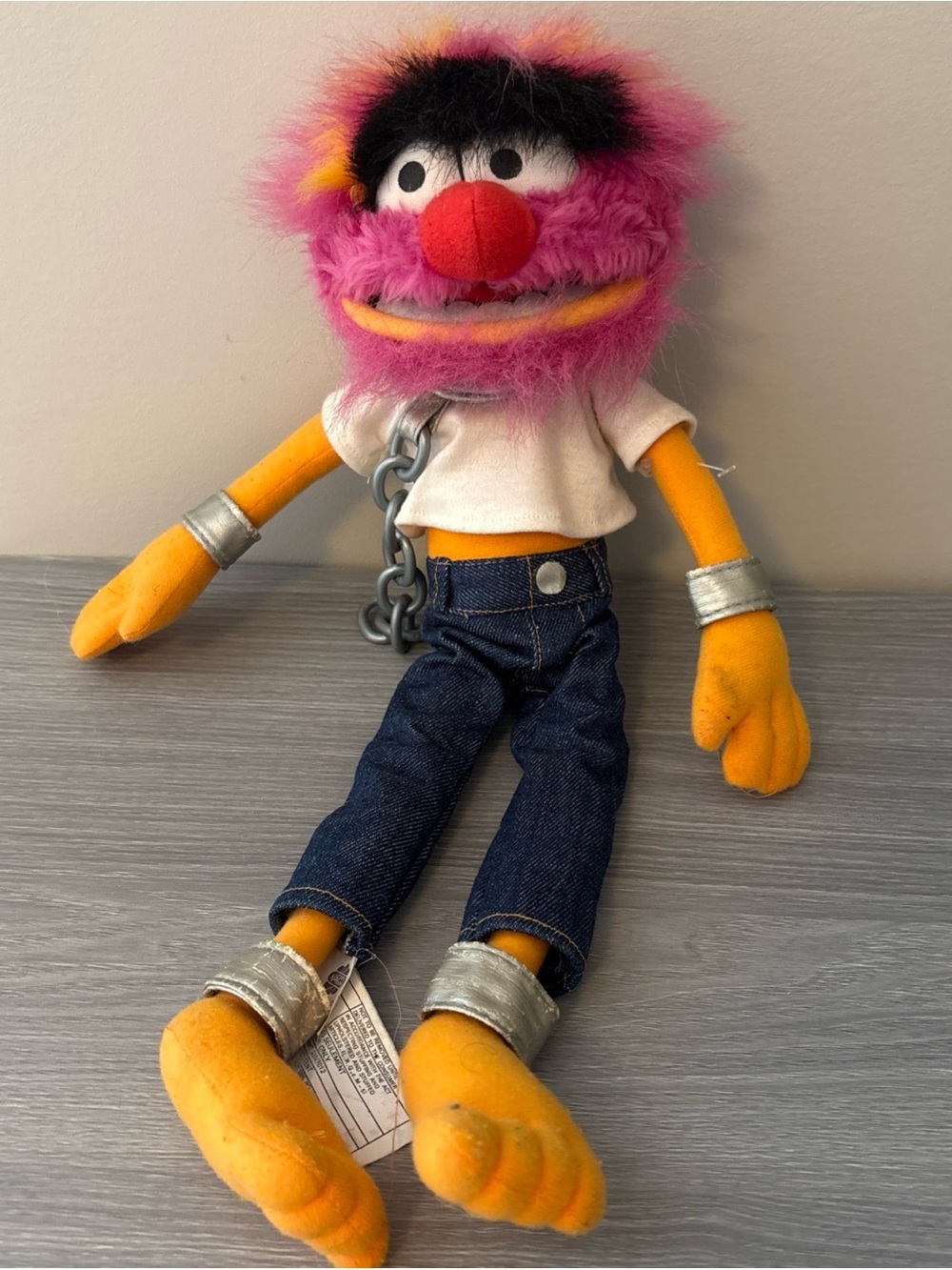 Pink Fuzzy Plush Character Toy with Denim Pants and Chain Accent